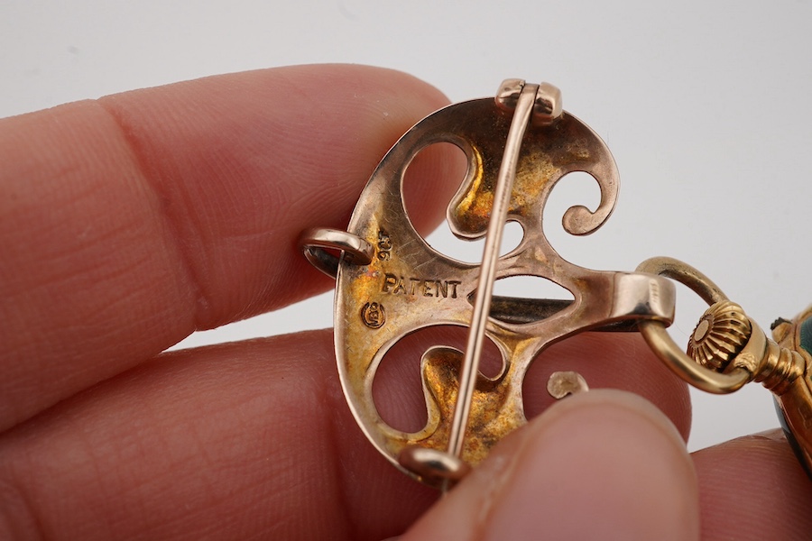 An early 20th century 18ct gold and two colour enamel open faced fob watch(enamel a.f.), with Arabic dial, case diameter 27mm, suspended from a Murrle Bennett & Co 9ct brooch. Condition - poor to fair